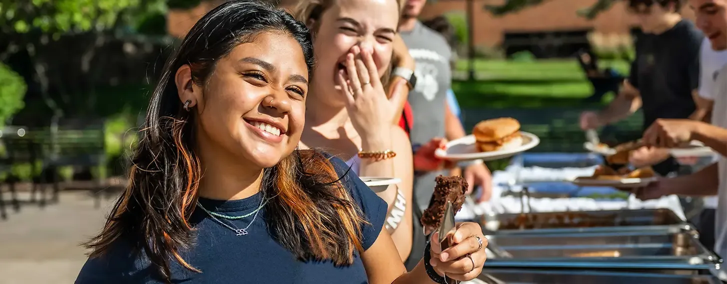 A student in line for food at and outside buffet